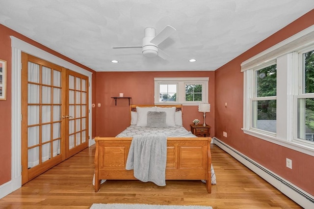 35 Warren Ave, Reading, MA 01867 - bedroom featuring baseboard heating, light wood-type flooring, french doors, recessed lighting, and a ceiling fan