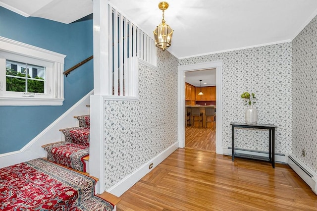 35 Warren Ave, Reading, MA 01867 - staircase with a chandelier, wood finished floors, crown molding, wallpapered walls, and baseboards