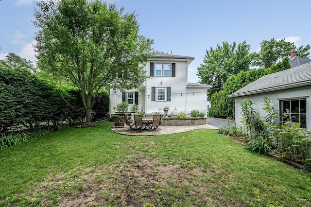 35 Warren Ave, Reading, MA 01867 - back of property featuring a patio area and a yard