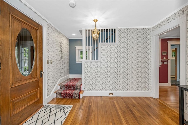 35 Warren Ave, Reading, MA 01867 - foyer entrance with crown molding, stairway, wallpapered walls, wood-type flooring, and a chandelier