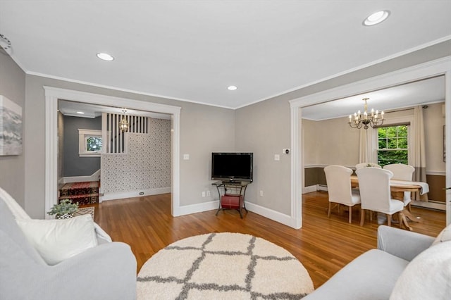 35 Warren Ave, Reading, MA 01867 - living room with a chandelier, wood finished floors, ornamental molding, baseboards, and stairway