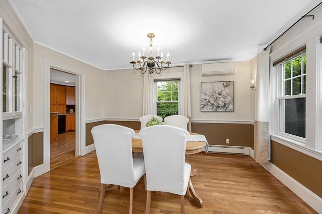 35 Warren Ave, Reading, MA 01867 - dining space featuring an AC wall unit, a baseboard radiator, a chandelier, and healthy amount of natural light