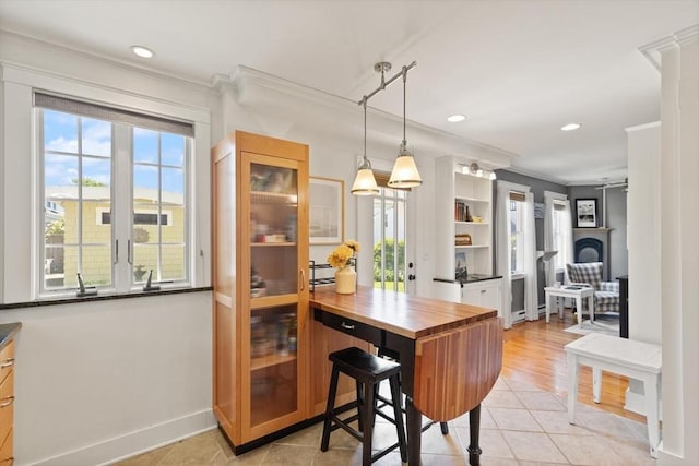 150 Prospect St Unit 3, Gloucester, MA 01930 - dining space featuring ornamental molding, light tile patterned floors, recessed lighting, and a fireplace