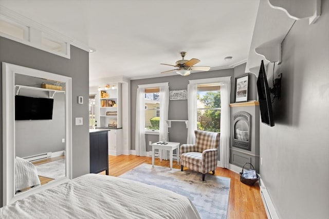150 Prospect St Unit 3, Gloucester, MA 01930 - bedroom featuring a baseboard radiator, light wood-style floors, ornamental molding, and ceiling fan