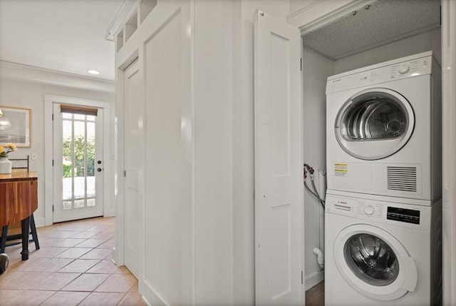 150 Prospect St Unit 3, Gloucester, MA 01930 - washroom featuring stacked washer and clothes dryer, light tile patterned floors, and recessed lighting