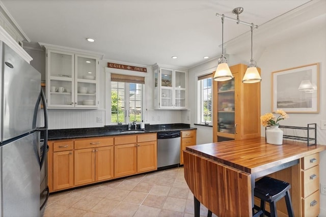 150 Prospect St Unit 3, Gloucester, MA 01930 - kitchen with freestanding refrigerator, stainless steel dishwasher, plenty of natural light, butcher block countertops, and recessed lighting