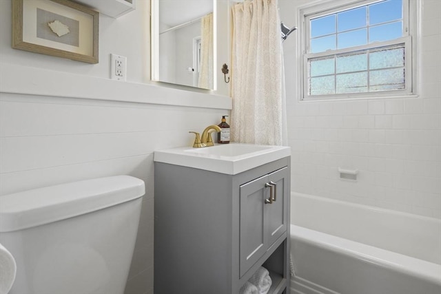 full bath with vanity, toilet, and shower / tub combo with curtain