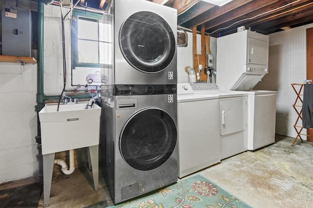 washroom featuring laundry area, stacked washer and clothes dryer, a sink, and electric panel