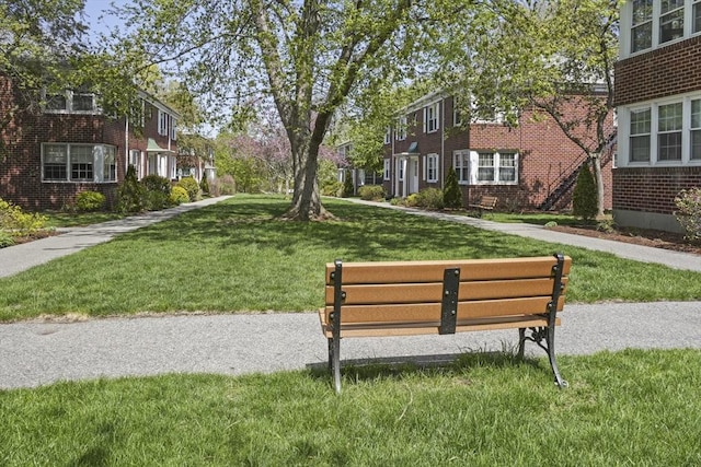 view of community featuring a lawn and a residential view