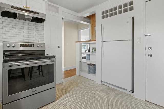 kitchen featuring freestanding refrigerator, decorative backsplash, white cabinetry, under cabinet range hood, and stainless steel range with electric cooktop