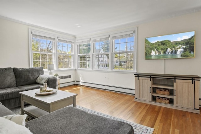 living room with ornamental molding, wood finished floors, and a baseboard radiator
