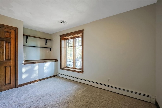 carpeted empty room with a baseboard radiator