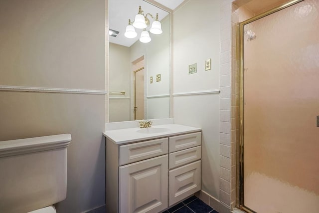 bathroom featuring tile patterned floors, vanity, toilet, and an enclosed shower