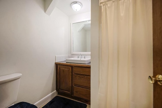 bathroom featuring vanity and toilet