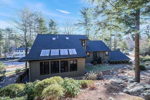 rear view of house featuring cooling unit