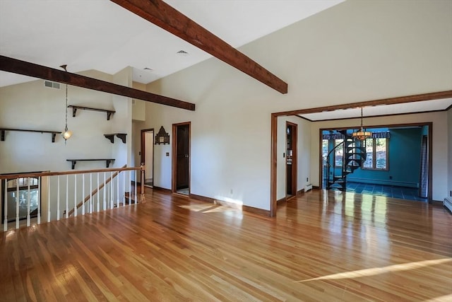 interior space featuring vaulted ceiling with beams, hardwood / wood-style flooring, and an inviting chandelier