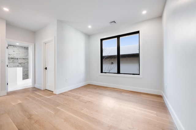 empty room with light hardwood / wood-style flooring