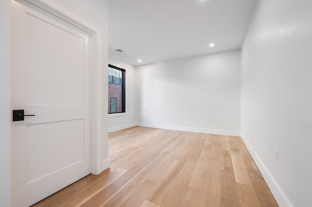 unfurnished room with light wood-type flooring