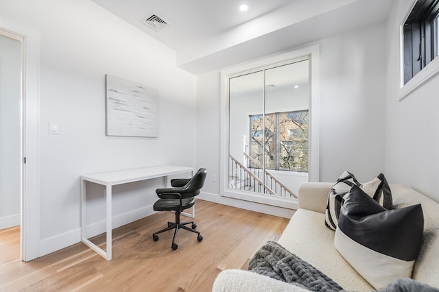 office with light wood-type flooring