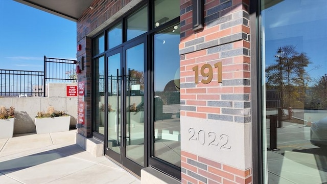 191 Washington St Unit 309, Boston, MA 02135 - property entrance featuring fence, french doors, and brick siding