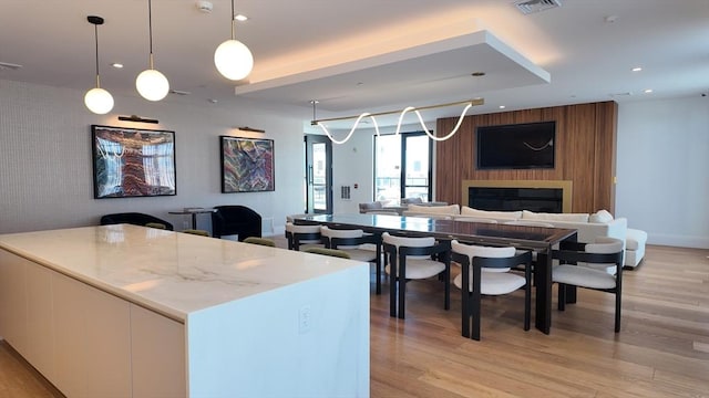 191 Washington St Unit 309, Boston, MA 02135 - kitchen featuring an accent wall, open floor plan, light wood finished floors, and recessed lighting
