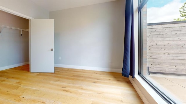 191 Washington St Unit 309, Boston, MA 02135 - unfurnished bedroom featuring light wood-style floors and baseboards