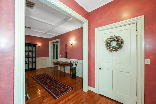 entrance foyer featuring crown molding, wood-type flooring, and coffered ceiling