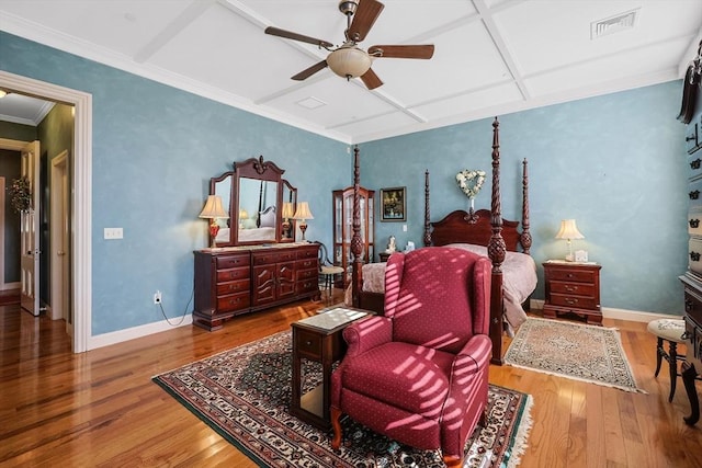 bedroom featuring ceiling fan, crown molding, coffered ceiling, and hardwood / wood-style floors