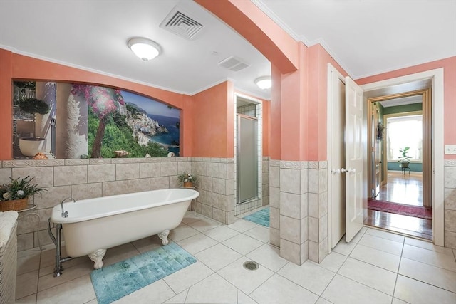 bathroom featuring tile patterned flooring, tile walls, separate shower and tub, and crown molding