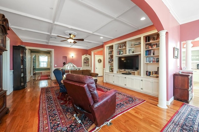 living room with ceiling fan, light hardwood / wood-style floors, beamed ceiling, coffered ceiling, and decorative columns