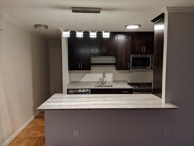 kitchen featuring ornamental molding, light stone countertops, baseboards, a sink, and stainless steel appliances