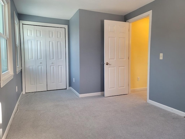 unfurnished bedroom featuring carpet and baseboards