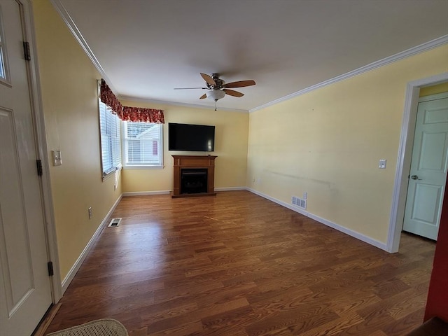 unfurnished living room featuring a fireplace, visible vents, crown molding, and wood finished floors