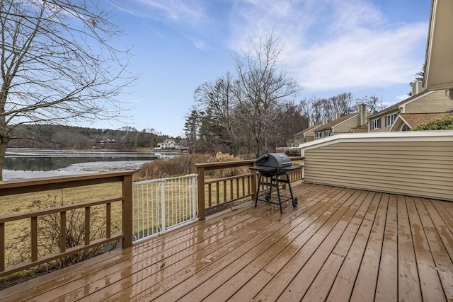 wooden terrace featuring a grill