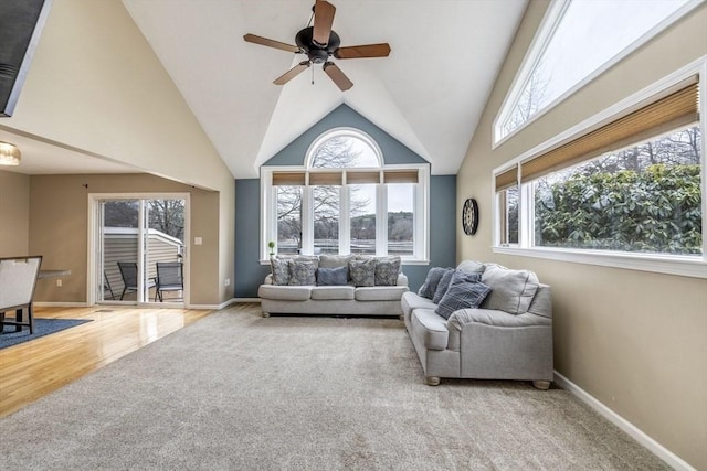 living room with baseboards, carpet floors, high vaulted ceiling, and a healthy amount of sunlight