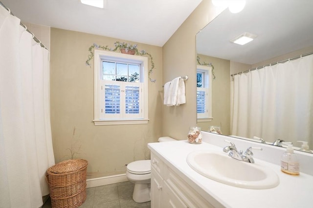 bathroom featuring toilet, tile patterned flooring, baseboards, and vanity