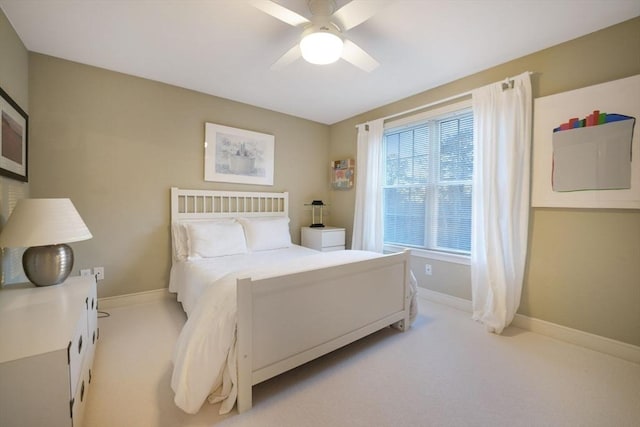 bedroom with light carpet, ceiling fan, and baseboards