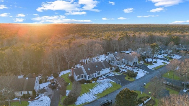 drone / aerial view featuring a forest view and a residential view