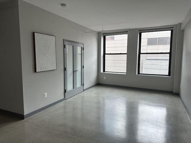 453 Washington St Unit 6C, Boston, MA 02113 - unfurnished room with a smoke detector, baseboards, and concrete flooring