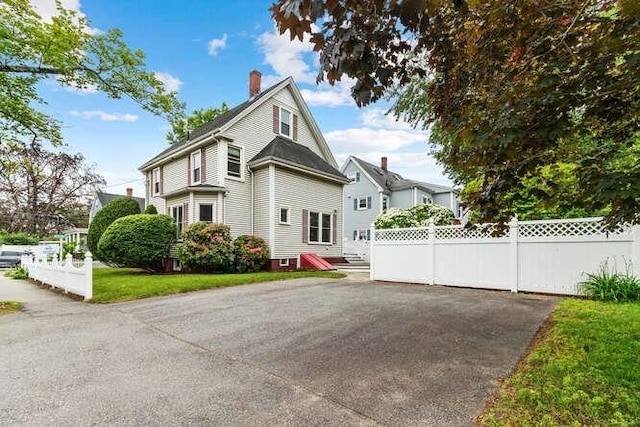6 Francis Ave, Wakefield, MA 01880 - view of home's exterior with a chimney and a patio