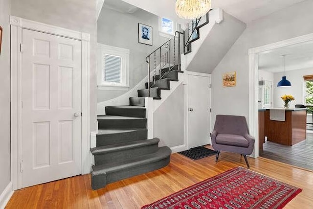 6 Francis Ave, Wakefield, MA 01880 - staircase featuring wood finished floors and a chandelier