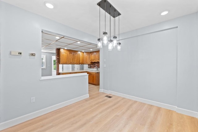 11 Shale St, Worcester, MA 01604 - kitchen featuring light countertops, light wood-style floors, recessed lighting, brown cabinets, and pendant lighting