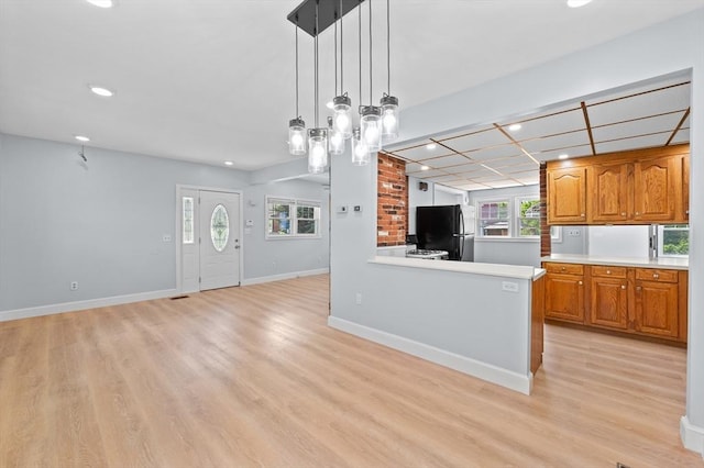 11 Shale St, Worcester, MA 01604 - kitchen with freestanding refrigerator, recessed lighting, light wood-style flooring, brown cabinetry, and light countertops