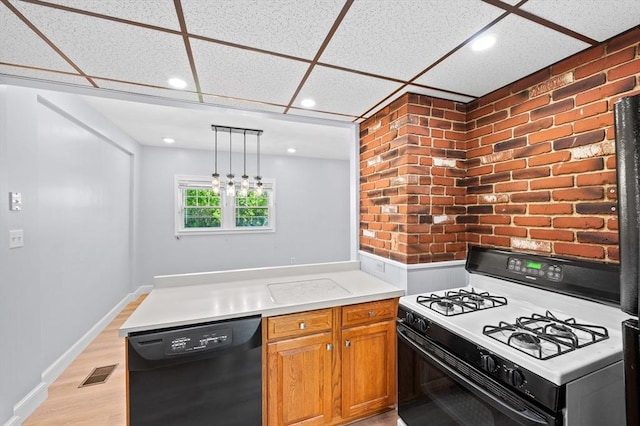 11 Shale St, Worcester, MA 01604 - kitchen with black dishwasher, gas range gas stove, a peninsula, a paneled ceiling, and recessed lighting