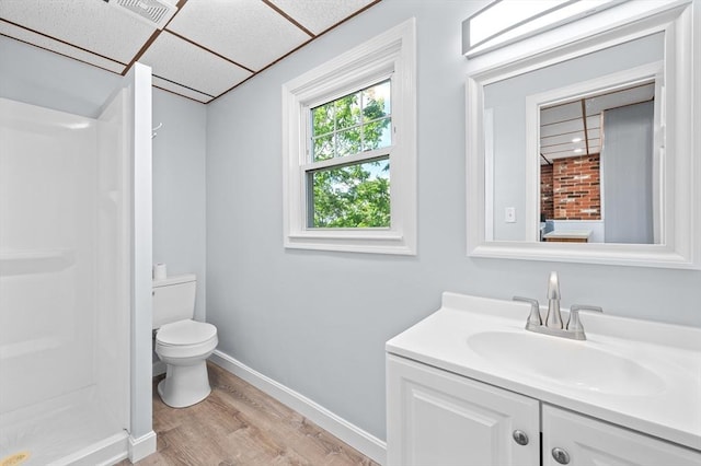 11 Shale St, Worcester, MA 01604 - bathroom with wood finished floors, vanity, toilet, a shower, and baseboards