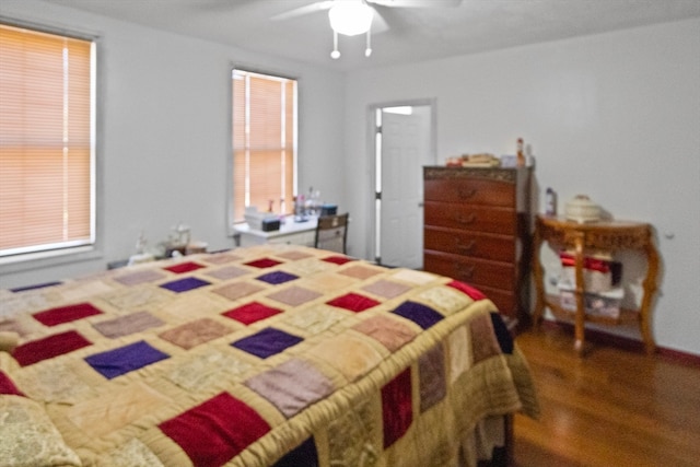 bedroom with dark hardwood / wood-style flooring, multiple windows, and ceiling fan