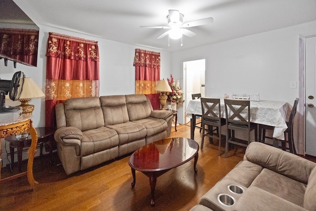 living room featuring hardwood / wood-style floors and ceiling fan