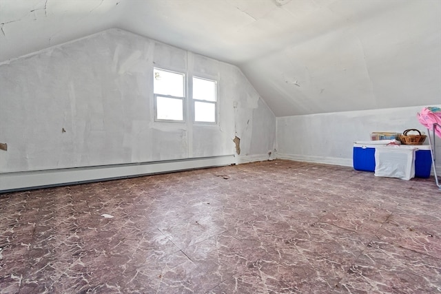 additional living space with a baseboard radiator and vaulted ceiling