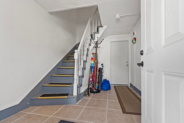 staircase with tile patterned flooring