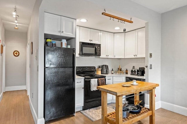 762 Tremont St Unit 5, Boston, MA 02118 - kitchen featuring black appliances, white cabinetry, decorative backsplash, light countertops, and recessed lighting